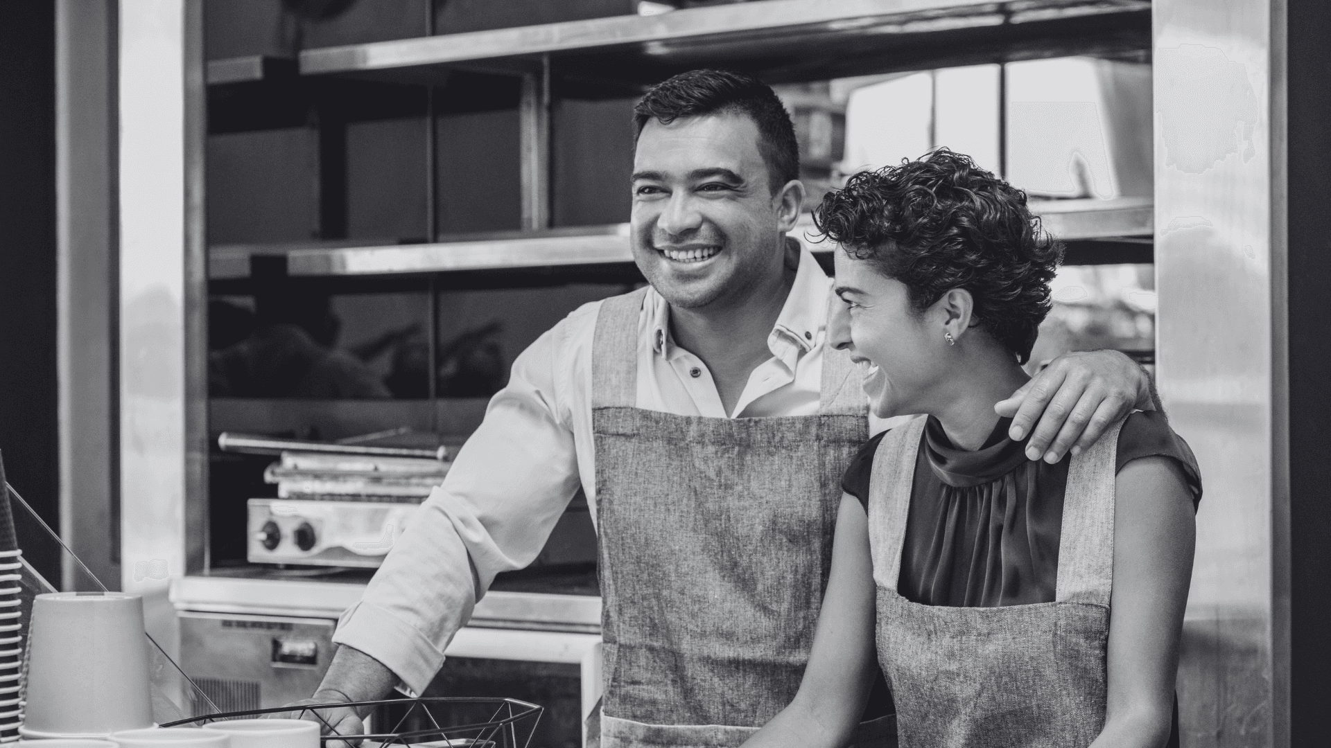 Two people smiling and working together